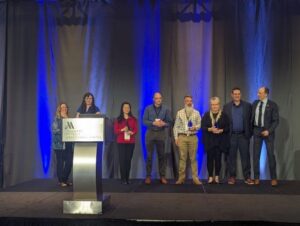 Photo of IUG 2024 Crystal Award winners standing on stage